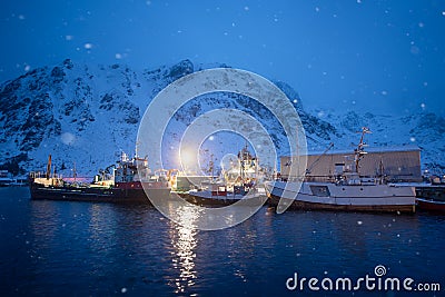 Snowing in Ballstad village at twilight in winter season, city the small harbour of Norwegian, Lofoten islands, Norway Stock Photo