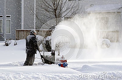 Snowing day worker blowing snow Stock Photo