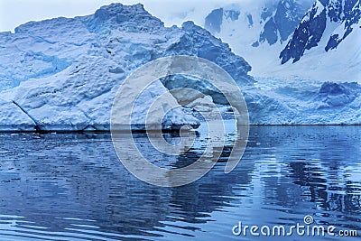 Snowing Floating Blue Iceberg Arch Reflection Paradise Bay Skintorp Cove Antarctica Stock Photo