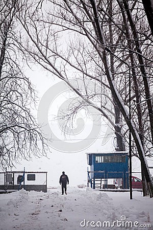 Snowing landscape in the park with people passing by Stock Photo