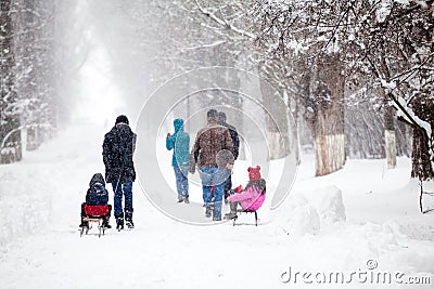 Snowing landscape in the park with people passing by Stock Photo