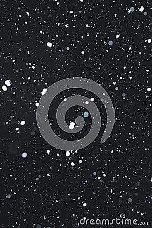 Snowing with snowflakes on black background Stock Photo