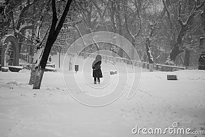 Snowing urban landscape with people Stock Photo