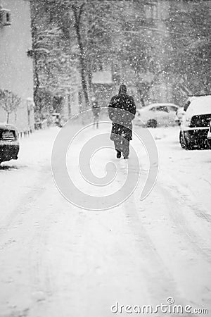 Snowing urban landscape with people Stock Photo
