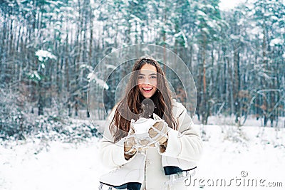 Snowing winter beauty fashion concept. Women in winter clothes. Outdoor close up portrait of young beautiful girl with Stock Photo