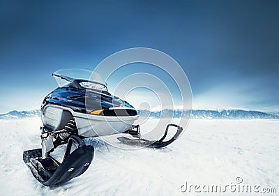 Snowmachine on the mountain lake frozen surface Stock Photo