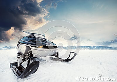 Snowmachine on the mountain lake frozen surface with thunderstorm clouds on the background Stock Photo