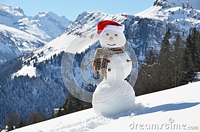 Snowman against Alpine panorama Stock Photo