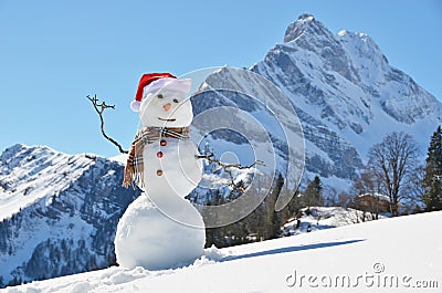 Snowman against Alpine panorama Stock Photo