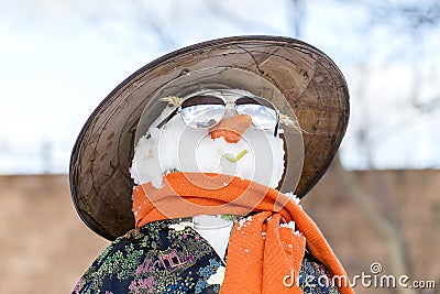 Snowman in Asian clothes in the yard. Ukraine Stock Photo