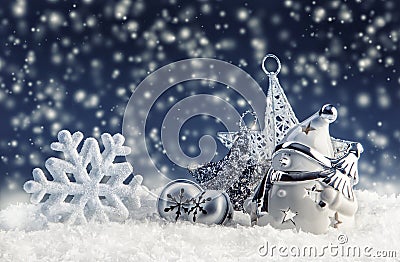 Snowman with christmas decoration and ornaments - jingle bells star snowflakes in snowy atmosphere. Stock Photo