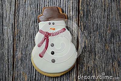 Snowman Cookie on Rustic Wood Background Stock Photo