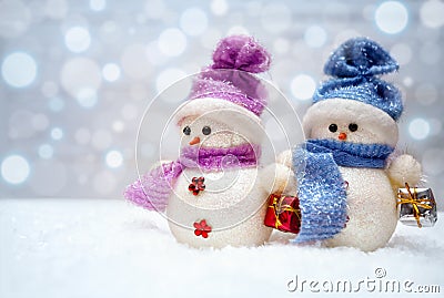 Snowman couple with scarfs Stock Photo