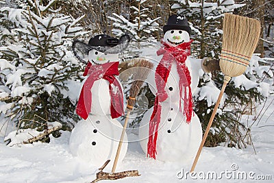 Snowman couple in winter - christmas outdoor decoration with snow Stock Photo