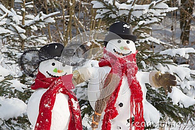 Snowman couple in winter - christmas outdoor decoration with snow Stock Photo