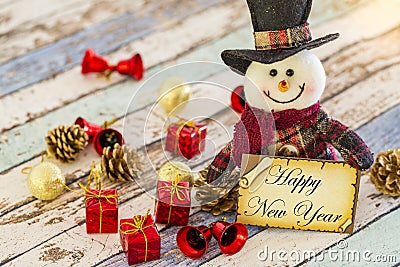 Snowman holding greeting card for new year or christmas with christmas ornaments Stock Photo