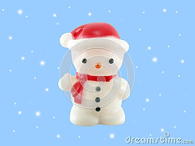 close up single snowman lamp wearing red hat and scarf with falling snow isolated on blue background Stock Photo