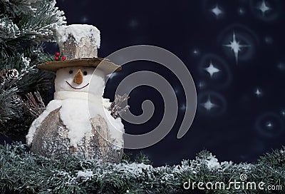 Snowman next to Christmas tree Stock Photo