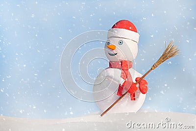 Snowman in red clothes with broom Stock Photo