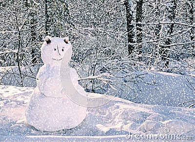 Snowman standing in snowy winter forest. Merry Christmas and Happy New Year greeting card with copy space. Stock Photo