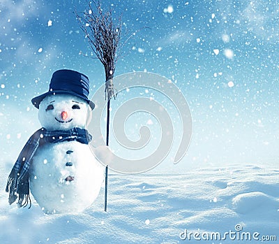 Snowman standing in winter christmas landscape Stock Photo