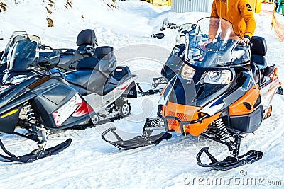 Snowmobile. Close-up of row of snowmobiles stand in snow, view from below, skiing. Stock Photo