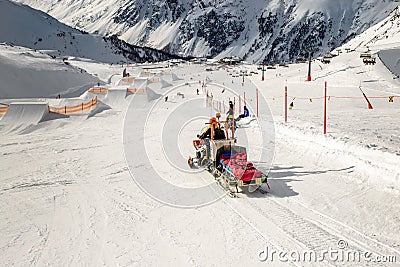 Snowmobile machine with sled and equipment riding fast hurry up driver to help injured skier or snowboarder at accident on winter Stock Photo