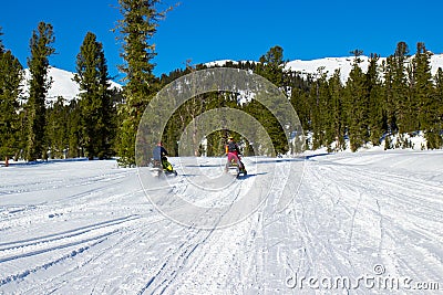 Snowmobile riding in mountains Editorial Stock Photo