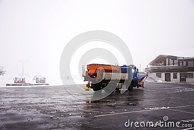 Snowploughs machinery plowing snow on ground at cable car station Stock Photo