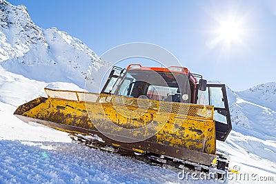 Snowplow in the mountains prepairing piste Stock Photo