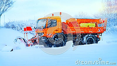 Snowplow removing the Snow from the Highway during a Snowstorm Stock Photo