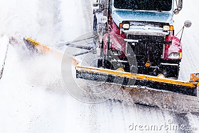 Snowplow removing the Snow from the Highway Stock Photo