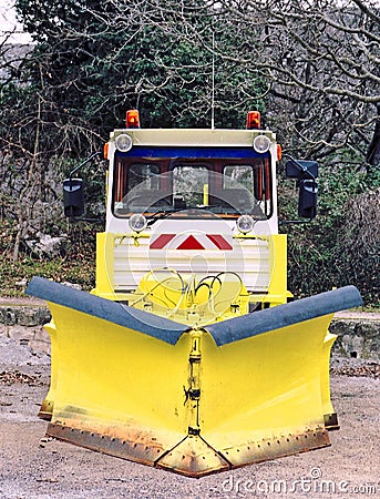 Snowplow at Rest: Off-Season Outdoor Parking Stock Photo