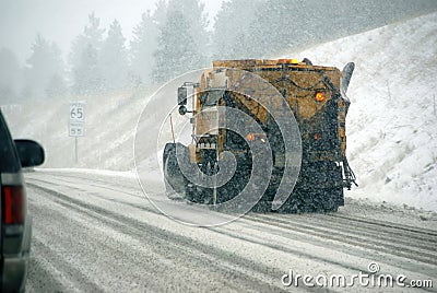 Snowplow truck on icy road Stock Photo