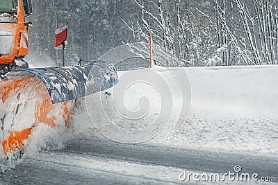 Snowplow truck removing dirty snow from city street or highway after heavy snowfalls. Traffic road situation. Weather forecast for Stock Photo