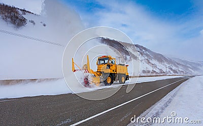 Snowplow truck Snow removal truck is removing the snow from the highway during a cold snowstorm winter day. Stock Photo