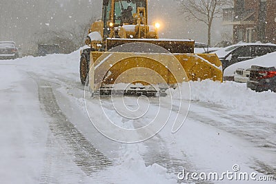 Snowplow trucks remove snow from parking lots following heavy a snowfalls Stock Photo