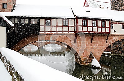 Snowstorm in old town Nuremberg, Germany - Executioner House over river Pegnitz Stock Photo