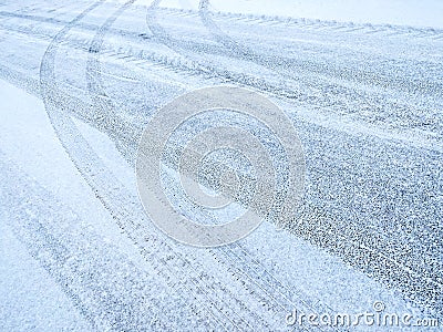 Snowy road background with crossing of tires imprints Stock Photo