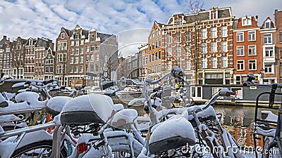 Snowy bikes in Amsterdam in winter in the Netherlands Stock Photo