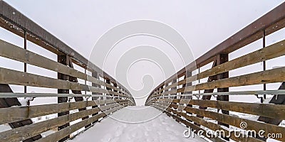 Snowy bridge against frosty landscape and sky Stock Photo