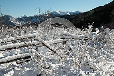 Snowy fence in Pyrenees Stock Photo