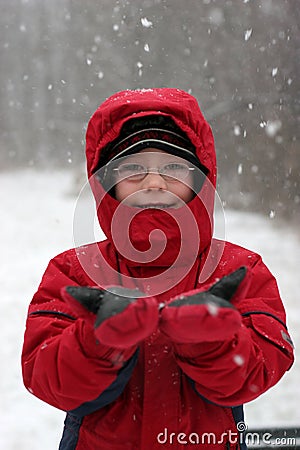 Snowy fun - boy in snowstorm Stock Photo