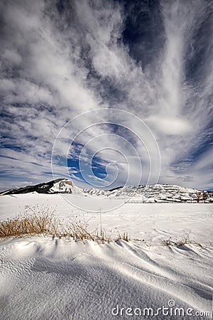 Snowy landscape on a sunny day and spectacular clouds Stock Photo