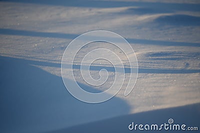 Snowy landscapes and snow close-up in sunbeams. Grass and objects in the snow Stock Photo