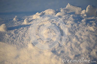 Snowy landscapes and snow close-up in sunbeams. Grass and objects in the snow Stock Photo