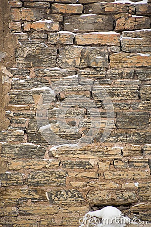 Snowy limestone stone wall with mortar in winter Stock Photo