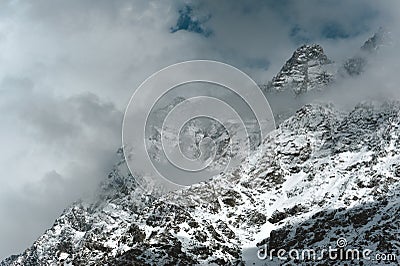 Snowy Mountain Himalayas peaks of Moon Peak, Indarhar pass, Dhauladhar Range cloudy sky Stock Photo