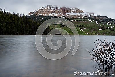 Snowy Mountain Peeks Out Across Beartooth Lake Stock Photo