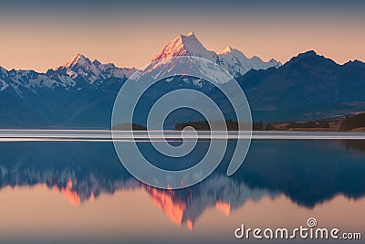 Snowy mountain range reflected in the still water of Lake Pukaki, Mount Cook, South Island, New Zealand. The turquoise water. Stock Photo